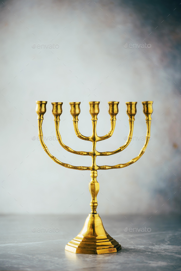 Golden hanukkah menorah on grey background. Jewish holiday banner with copy space. Ancient